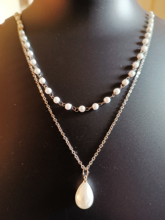 A silver-plated double-layered pearl droplet neckpiece displayed on a mannequin bust.