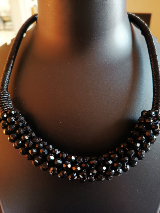 A single-layered black beads choker neckpiece displayed on a mannequin bust.