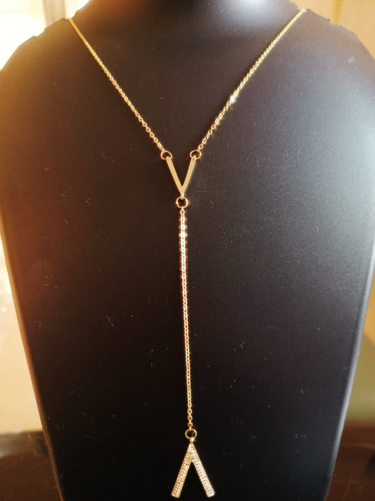 Gold-plated, diamond-studded single-layered long V neckpiece displayed on a mannequin bust.