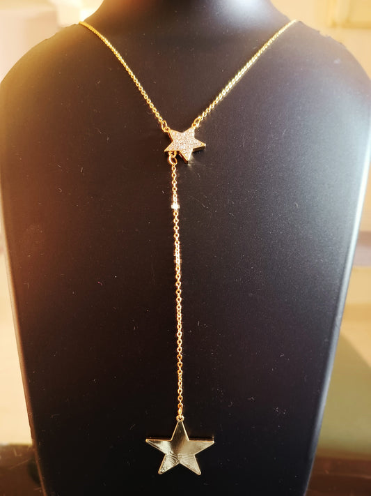 Gold-plated, diamond-studded single-layered long star neckpiece displayed on a mannequin bust.
