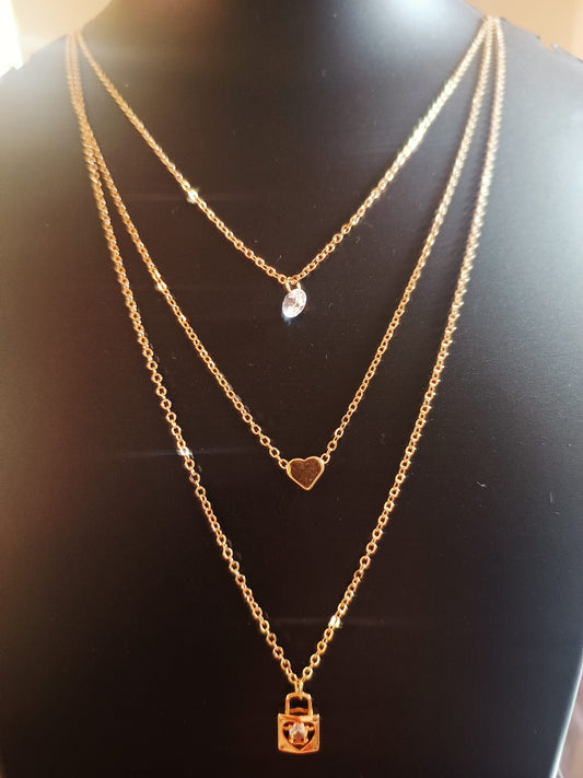 A gold-plated, three-layered neckpiece with a heart-solitaire-lock design displayed on a mannequin.