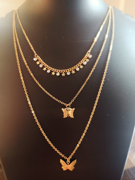 A three layered gold-plated neckpiece with butterfly charms on each layer, displayed on a mannequin.