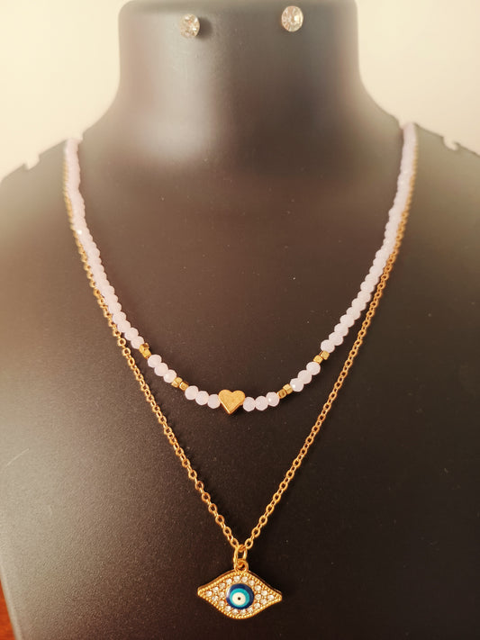 A gold-plated double-layered pink beads neckpiece with a geometric pattern, displayed on a mannequin bust.