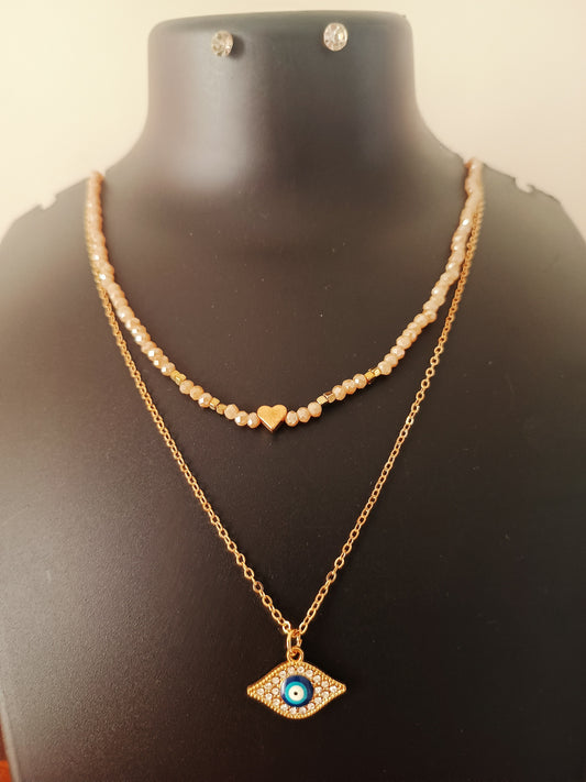 A gold-plated beige beads double-layered evil-eye neckpiece with earrings displayed on a mannequin.